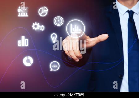 Core values concept. Businessman pointing at icon on virtual screen Stock Photo