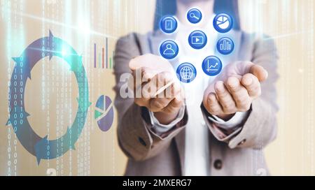 Woman demonstrating icons of data management system and digital charts ...