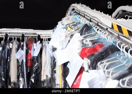 Hangers With Clothes On Garment Conveyor At Dry-cleaner's Stock Photo,  Picture and Royalty Free Image. Image 198000170.