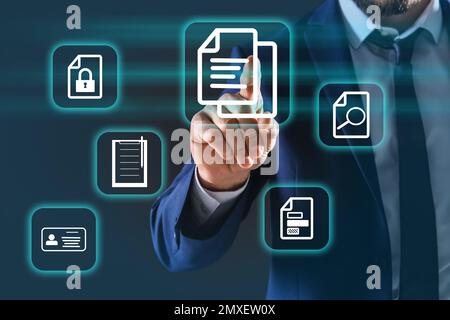 Man pointing at document icon on virtual screen, closeup Stock Photo
