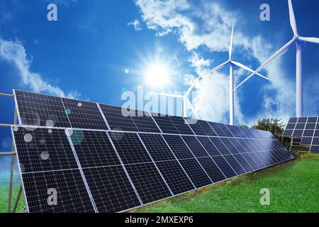 Solar panels and wind turbines installed outdoors. Alternative energy source Stock Photo