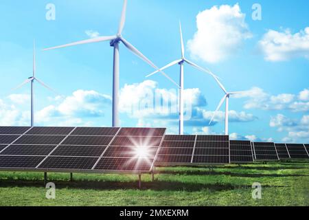 Solar panels and wind turbines installed outdoors. Alternative energy source Stock Photo