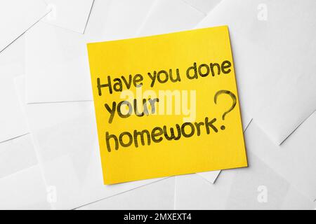 Note with phrase HAVE YOU DONE YOUR HOMEWORK? on paper sheets, top view Stock Photo