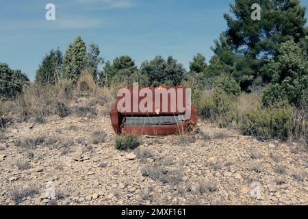Old abandoned sofa in the middle of the mountain. Stock Photo