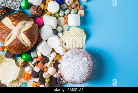 Unhealthy products. food bad for figure, skin, heart and teeth. Assortment of fast carbohydrates food with candy Stock Photo