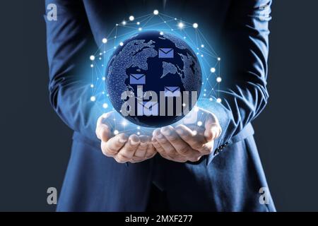 Electronic mail. Businessman demonstrating virtual image of globe, closeup Stock Photo