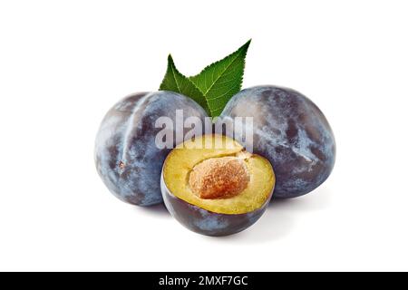 Two and half juicy and ripe plums with leaves on white background Stock Photo