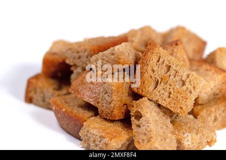 Toasted bread cubes against white background Stock Photo