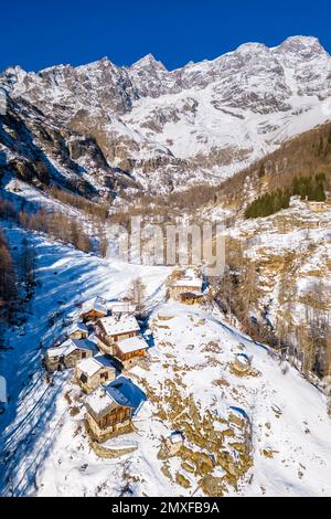 Aerial view of the Pastore Refuge and Monte Rosa at dawn in winter. Alpe Pile, Alagna, Valsesia, Alagna, Valsesia, Vercelli province, Piedmont, Italy, Stock Photo