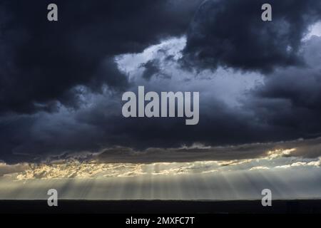 Bright sunrays cut through dark, ominous storm clouds hovering over midtown Atlanta Stock Photo