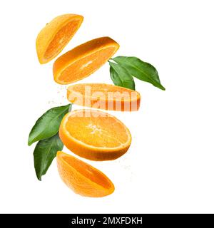 Orange fruit sliced with leaves and juice drops, isolated on white background. Stock Photo