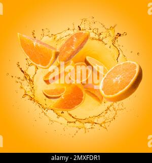 Orange slices jumping out of splashing orange juice on gradient background. Stock Photo
