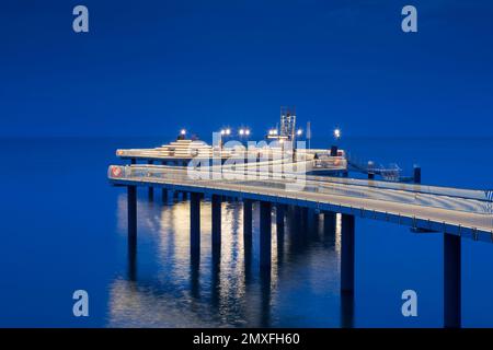 Koserow Pier / Seebrücke illuminated at night on Usedom island in the Baltic Sea, Mecklenburg-Vorpommern, Germany Stock Photo