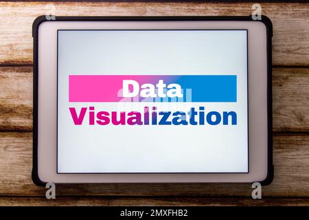 Conceptual keyword “Data Visualization” on tablet on faded shabby table. Visualize the data for business purpose concept. Stock Photo