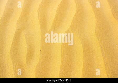 Rippled texture of golden sand Stock Photo
