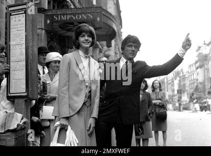 Dave Clark of the Dave Clark Five hailing a taxi outside Simpson's on the Strand in London 1968 Stock Photo