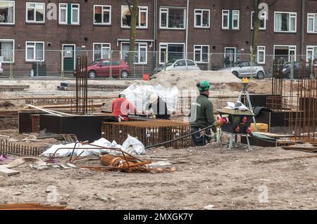 concrete workers at work on a construction site Stock Photo