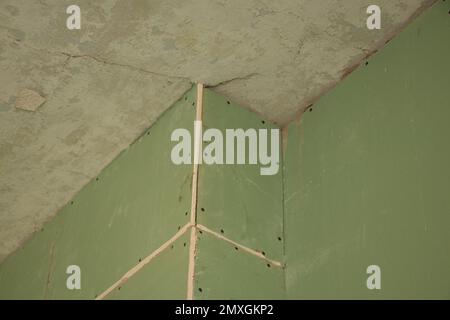 the wall is sheathed with moisture-resistant green plasterboard in the apartment, renovation work at home Stock Photo