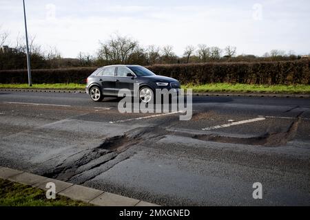 Pot Hole Potholes in Road Surface A414 Church Langley Roundabout Harlow Essex Stock Photo