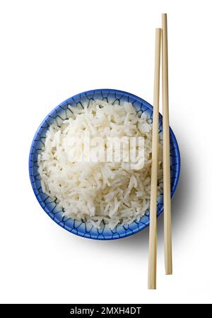 bowl of boiled rice and chopsticks isolated on white background, top view Stock Photo
