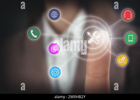 Businesswoman touching icon on virtual screen, closeup. Technical support Stock Photo