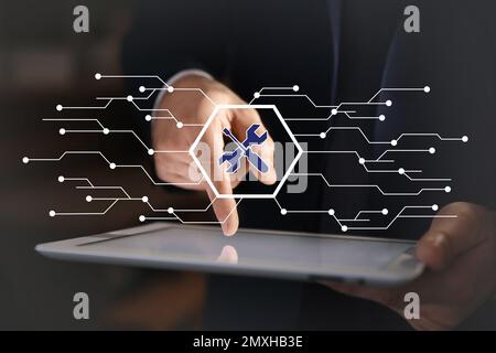 Man using tablet at workplace, closeup. Technical support Stock Photo