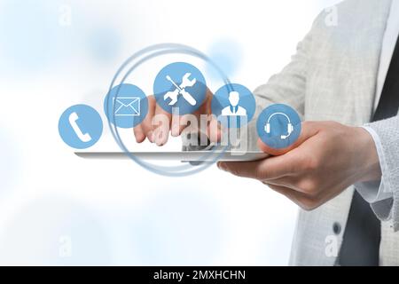Man using tablet on white background, closeup. Technical support Stock Photo