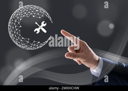 Man touching virtual screen with illustration of Earth on dark background, closeup. Technical support Stock Photo