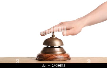 Woman ringing hotel service bell at wooden table Stock Photo