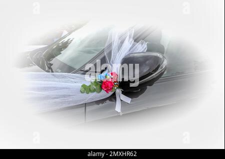 decorated black car vith white ribons and red roses for a newly wedded couple, Denmark, september 3, 2022 Stock Photo