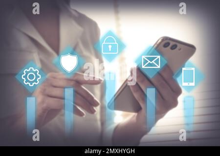 Information security. Young woman using smartphone indoors, closeup Stock Photo