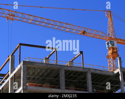 construction crane on high rise building Stock Photo