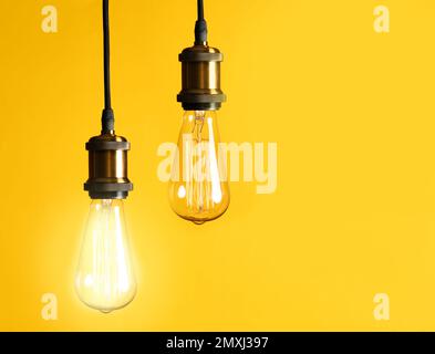Idea concept. Light bulbs on yellow background, space for text Stock Photo