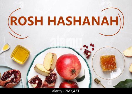Honey, apples and pomegranates on white table, flat lay. Rosh Hashanah holiday Stock Photo