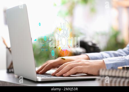 Woman working with laptop at table, closeup. Modern technology concept Stock Photo