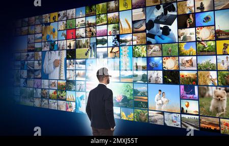 Media library concept. Man using virtual video gallery Stock Photo