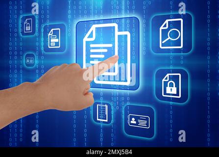 Man pointing at document icon on virtual screen, closeup Stock Photo