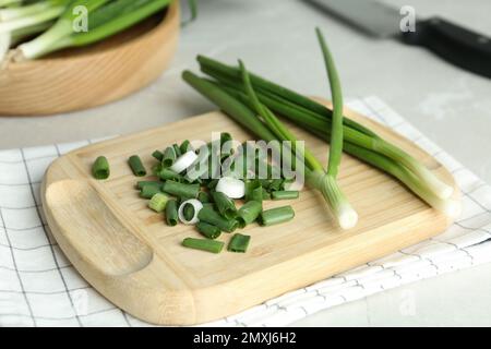 Fresh green spring onions on wooden board Stock Photo