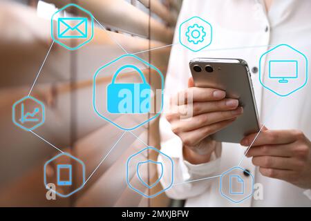 Information security. Young woman using smartphone indoors, closeup Stock Photo