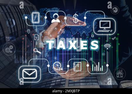 Tax concept. Man demonstrating scheme with icons Stock Photo - Alamy