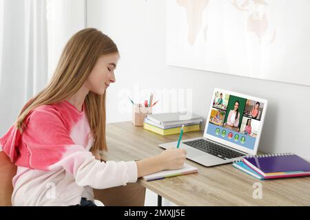 Distance learning during quarantine and lockdown due to Covid-19 pandemic. Girl having online school lesson with class at home Stock Photo
