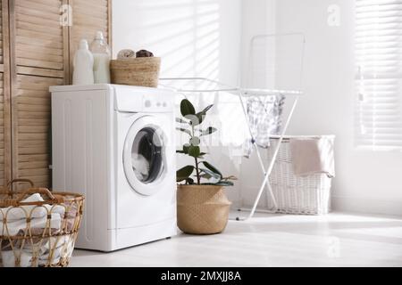 Modern washing machine in laundry room interior Stock Photo