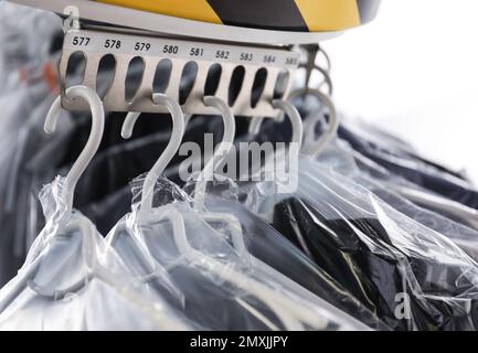 Hangers With Clothes On Garment Conveyor At Dry-cleaner's Stock Photo,  Picture and Royalty Free Image. Image 198000170.