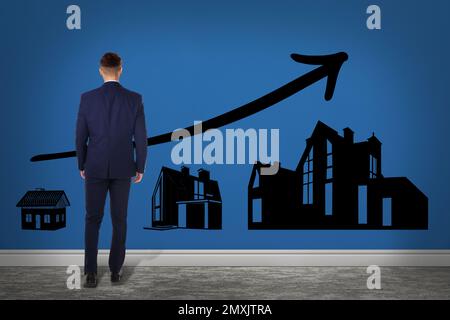 Real estate agent demonstrating prices at housing market. Man looking on graph illustration Stock Photo