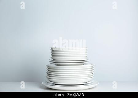 Stack of clean plates on white background Stock Photo