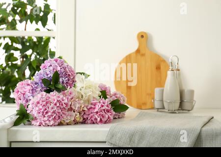 Beautiful hydrangea flowers bouquet on light countertop Stock Photo