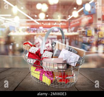 Boxing day concept. Shopping basket with gifts in supermarket Stock Photo