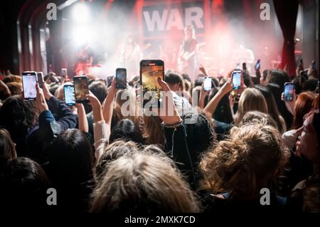 London, UK, Friday, 3rd February 2023 Mobile phones held up above the audience filming Beabadoobee (Beatrice Kristi Ilejay Laus) on stage as part of the War Child, Brit Awards week gigs at Lafayette, Kings Cross. Credit: DavidJensen / Empics Entertainment / Alamy Live News Stock Photo