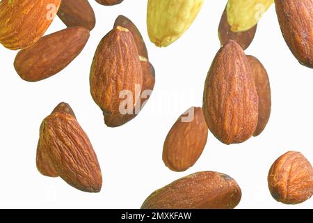 Falling almond isolated on a white background, selective focus. Almond nuts levitate on a white background. Freeze motion of flying whole almonds. Stu Stock Photo
