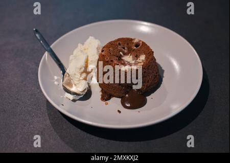 Chocolate lava cake and cream on plate on the table Stock Photo